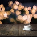 Cup of black coffee on wooden table in cafe. Christmas lights and gold garland on background Royalty Free Stock Photo