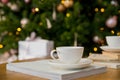 Cup of black coffee on wooden table in cafe. Christmas lights and gold garland on background. Atmospheric winter hygge Royalty Free Stock Photo