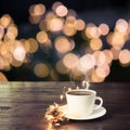 Cup of black coffee on wooden table in cafe. Christmas lights and gold garland on background Royalty Free Stock Photo