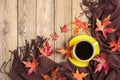 Cup with black coffee, yellow lollipops, macaroons, textile scarf, notepad, wooden table with autumn fallen orange leaves Royalty Free Stock Photo