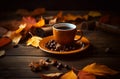 Cup of black coffee and autumn leaves on wooden table.