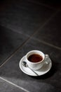 Cup of black filter coffee on the floor daylight sunlight morning coffeebreak spoon