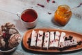 Cup of black tea with berry marshmallow and biscuits and jar of jam close up. Tea brake set Royalty Free Stock Photo