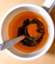 Cup of black tea with brew and spoon top view Royalty Free Stock Photo