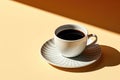 Cup of black tea or coffee on a yellow background with a hard refreshment