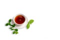 A Cup of black tea on a saucer with mint leaves on a white isolated background. Royalty Free Stock Photo