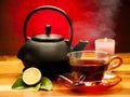A cup of black tea with teapot in the background Royalty Free Stock Photo