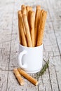 Cup with bread sticks grissini and rosemary Royalty Free Stock Photo