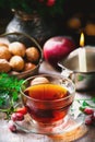 Cup of briar tea on a Christmas rustic background.