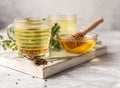 Cup with buckwheat tea, granules and honey, light grey background. Superfood Taiwan Ku Qiao buckwheat tea and grits of tartary