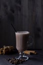 Cup of cacao. glass of hot chocolate with whipped cream, coffee beans and cinnamon sticks on a dark background. Royalty Free Stock Photo