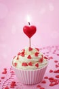 Cup cake with heart candle