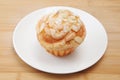 Cup cake muffin with almond and suggar on a plate on cutting board Royalty Free Stock Photo