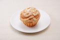 Cup cake muffin with almond and suggar on a plate on table cloth Royalty Free Stock Photo