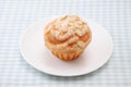 Cup cake muffin with almond and suggar on a plate on table cloth Royalty Free Stock Photo