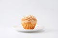 Cup cake muffin with almond and suggar on a plate on white background Royalty Free Stock Photo