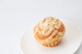 Cup cake muffin with almond and suggar on a plate on white background Royalty Free Stock Photo