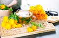 Cup of calendula infusion tea with fresh marigold flowers Royalty Free Stock Photo