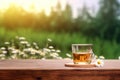 A cup of camomile tea on wooden table and camomile flowers in the morning with nature background. Generative AI Royalty Free Stock Photo