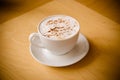 Cup of cappucchino over wooden table Royalty Free Stock Photo
