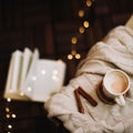 Cup of cappuccino with a book on dark wooden background. Coffee break. Top view. flatlay. cozy home