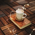 Cup of cappuccino with a book on dark wooden background. Coffee break. Top view. flatlay. cozy home