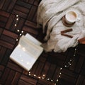 Cup of cappuccino with a book on dark wooden background. Coffee break. Top view. flatlay. cozy home