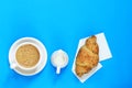 Coffee and croissant on a blue background Royalty Free Stock Photo