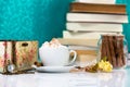 Cup of cappuccino with chocolate rolls and books in background. Royalty Free Stock Photo