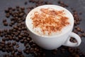 Cup of cappuccino coffee and coffee beans Royalty Free Stock Photo