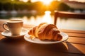 Cup of cappuccino coffee with croissant on wooden table Royalty Free Stock Photo