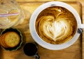 Cup of cappuccino coffee with heart shape latte art on old wood table Background, Latte coffee on old wooden Background table Royalty Free Stock Photo