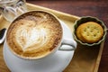 Cup of cappuccino coffee with heart shape latte art on old wood table Background, Latte coffee on old wooden Background table Royalty Free Stock Photo