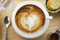 Cup of cappuccino coffee with heart shape latte art on old wood table Background, Latte coffee on old wooden Background table Royalty Free Stock Photo