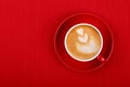 Cup of cappuccino coffee on red saucer Royalty Free Stock Photo