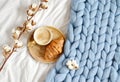 Cup with cappuccino, croissant, blue pastel giant plaid