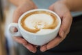 A cup of Cappuccino in the female hands