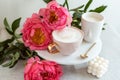 Cup with cappuccino, flowers peony, morning concept