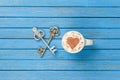 Cup of Cappuccino with heart shape symbol and two keys