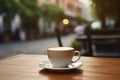 cup with cappuccino and canella (cinnamon) on wooden table at street cafe (coffe bar Royalty Free Stock Photo