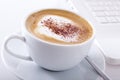 Cup of cappuccino with laptop Royalty Free Stock Photo