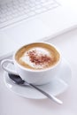 Cup of cappuccino with laptop Royalty Free Stock Photo