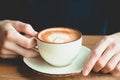 A cup of cappuccino in man`s hands. Aroma coffe. Morning Royalty Free Stock Photo