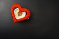 On a cup of cappuccino a red heart on a black background with a place for the text Royalty Free Stock Photo