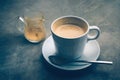 a cup of cappuccino on rustic dark blue cement board still life