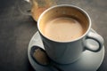 a cup of cappuccino on rustic dark blue cement board still life