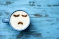 Cup of cappuccino with a sad face Royalty Free Stock Photo