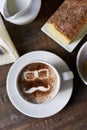 Man face in a cup of cappuccino