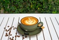 Cup of cappuccino with spoon and sugar on wooden white table side view Royalty Free Stock Photo