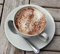 Cup of Cappuccino on wooden slat table